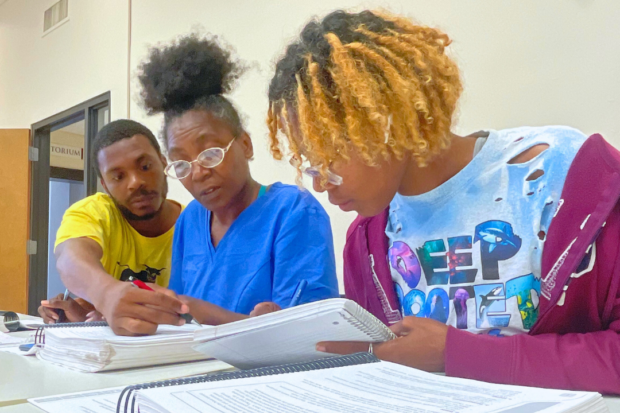 Students working together on a group activity in the Roots of Success student workbook